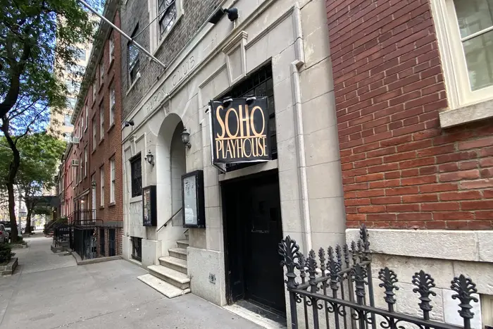 The Soho Playhouse, with a sign hanging, on a stree